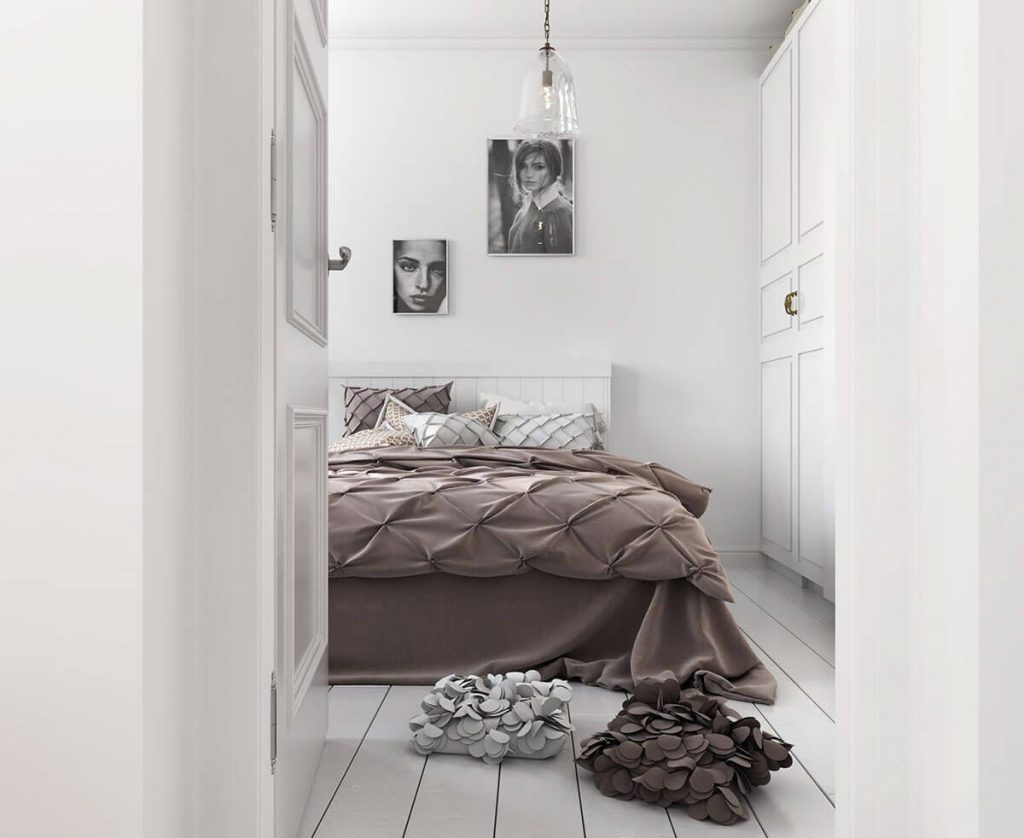 北欧スタイルのベッドルームには大きなベッドと茶色の寝具があります 
