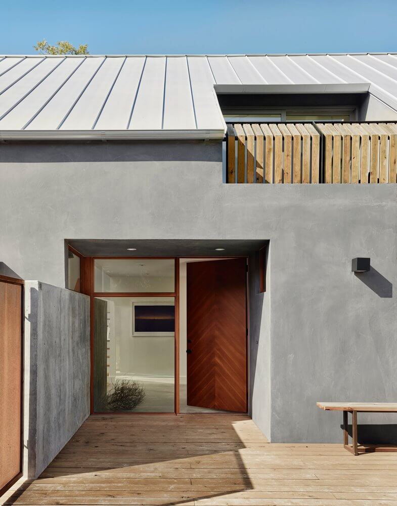 The outer space of the 2-storey Thai roof house is paved with wood