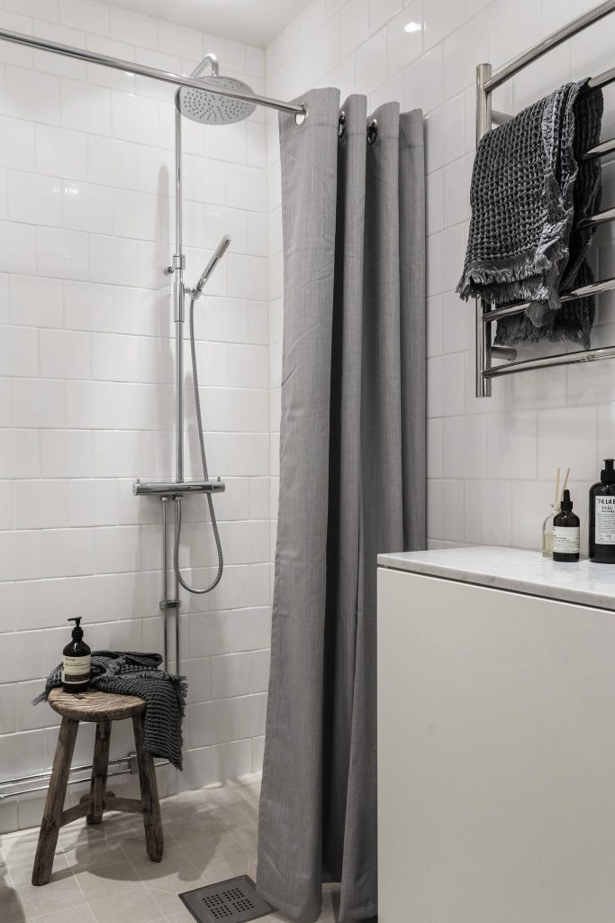 gray toilet curtain and standing shower 