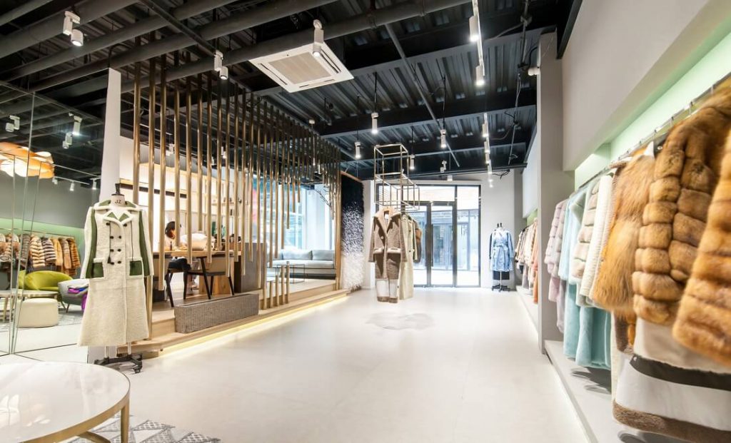 Spacious lobby is arranged with shelves displaying clothing products, many LEDs 